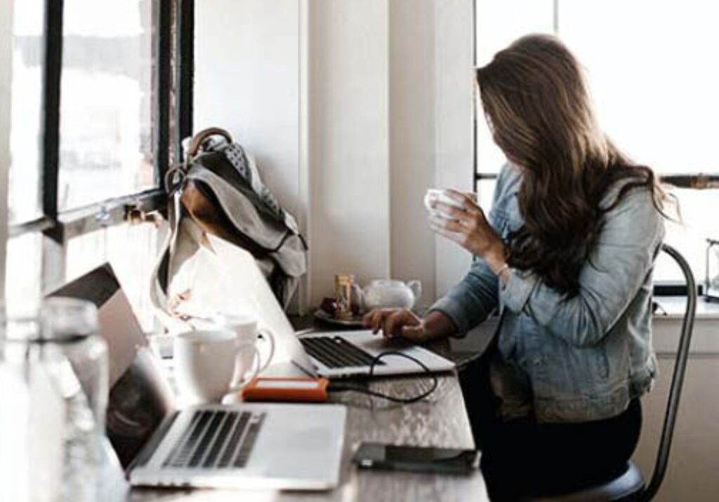 Woman working with coffee in her hand